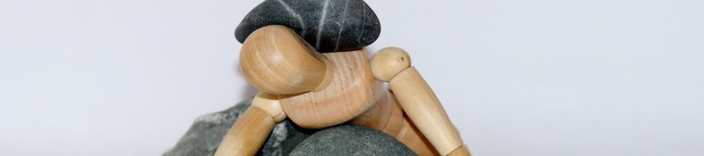 wooden figure, stones, struggle for life-980784.jpg
